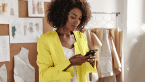 What is an Account Servicing Payment Service Provider (ASPSP) header image with a woman holding a phone wearing a yellow jacket